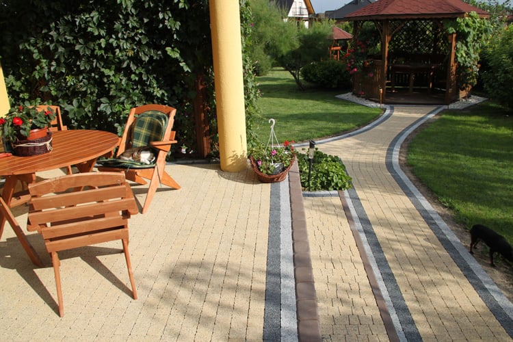 Landscaped garden with paved walkway and new fencing
